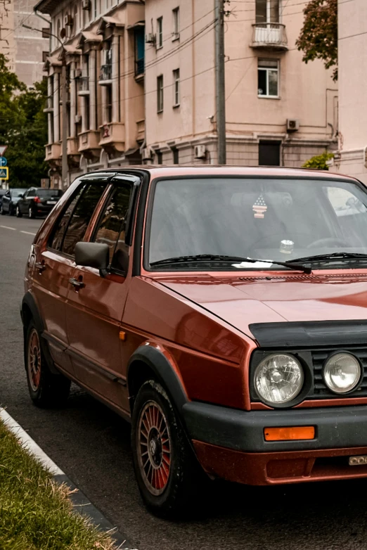 an old volkswagen is driving on the street