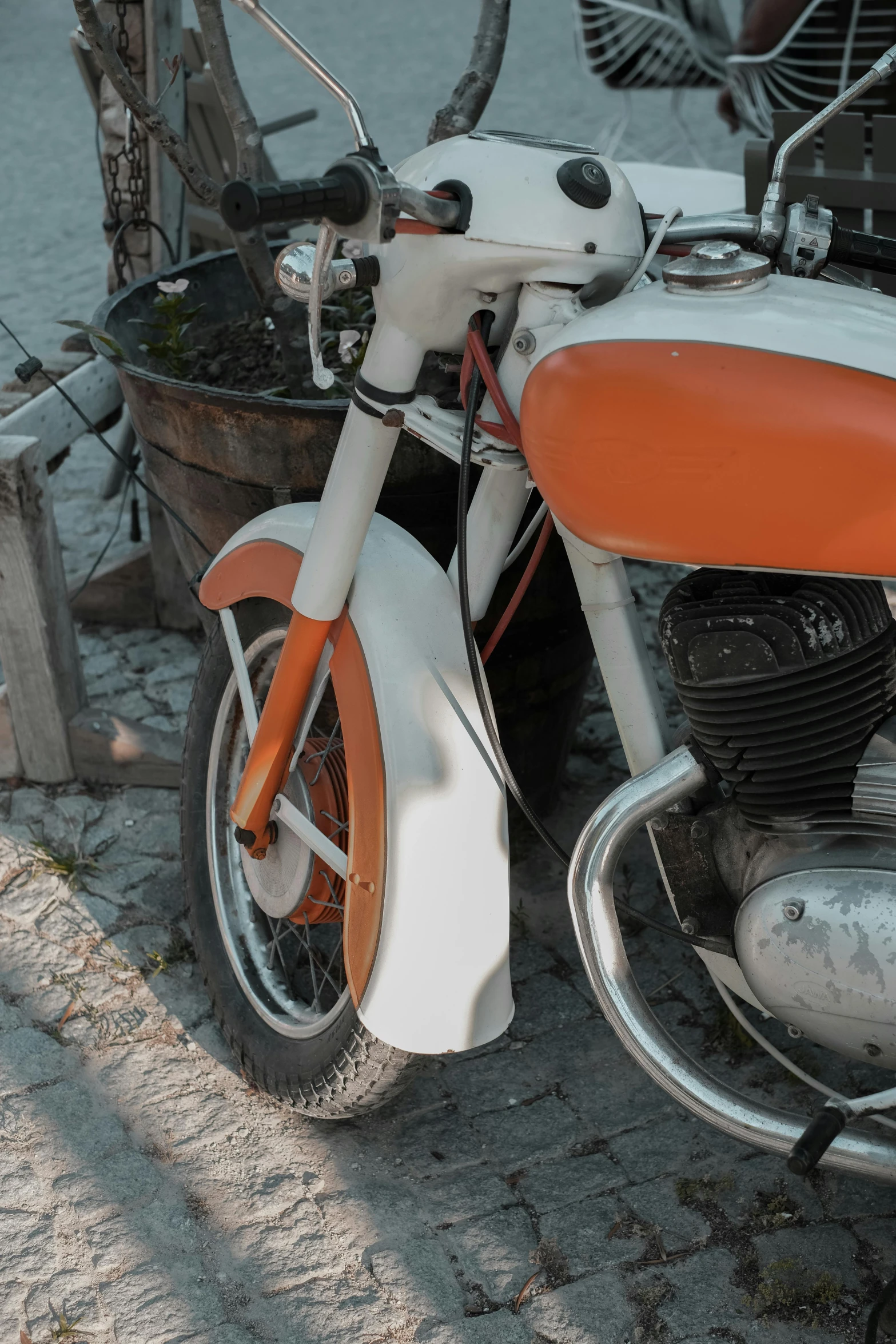 an old motorcycle that is painted in orange and white