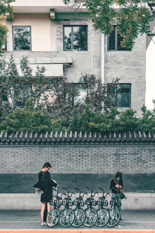 two people looking at a line of bicycles with a camera