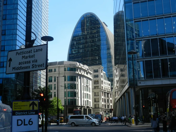 cars are driving along the street near large buildings