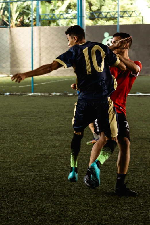 two men are playing soccer in a field