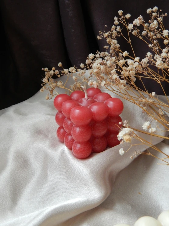 small group of balls sitting on a table next to flowers