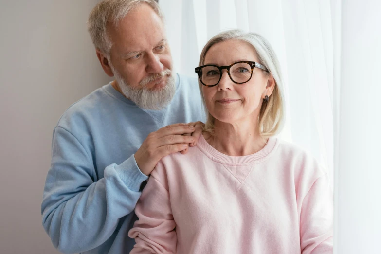 an old couple has their hands under his jacket