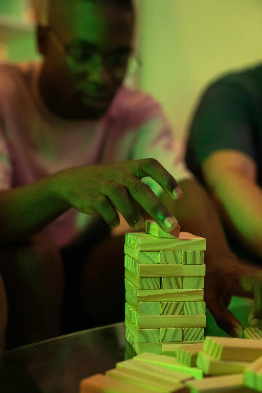 two people who are sitting around playing with green lights