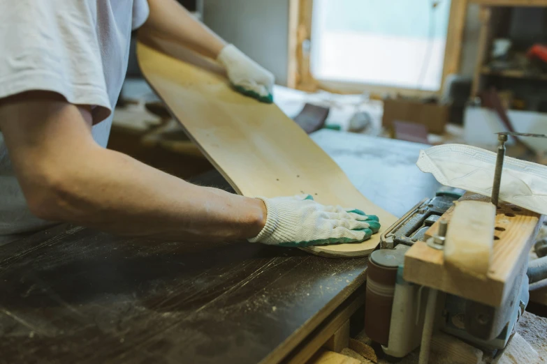 a person working on some wood in a room