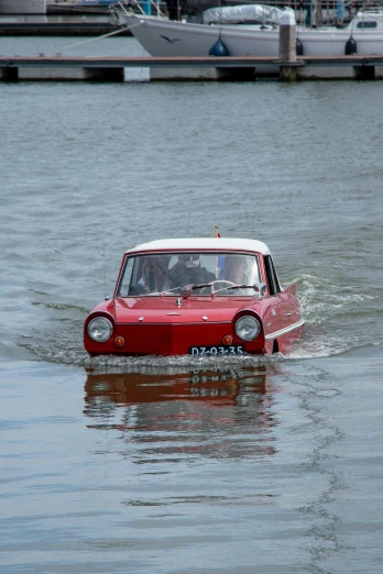 the small car is driving through the water