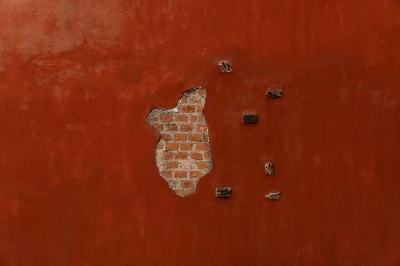 there is a picture of a brick animal that is on the wall