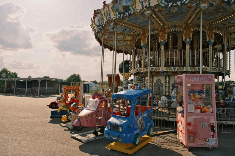 several toy cars and a carousel in the middle of a street