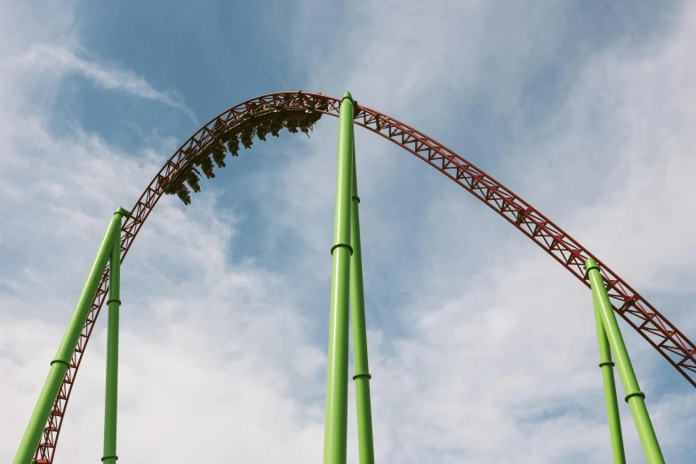 roller coaster against the sky with clouds in the background