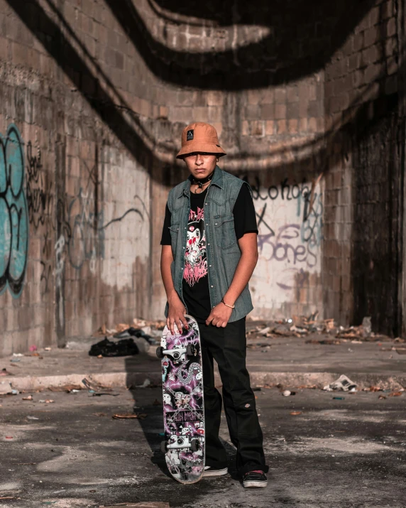 a person with a skate board in front of graffiti