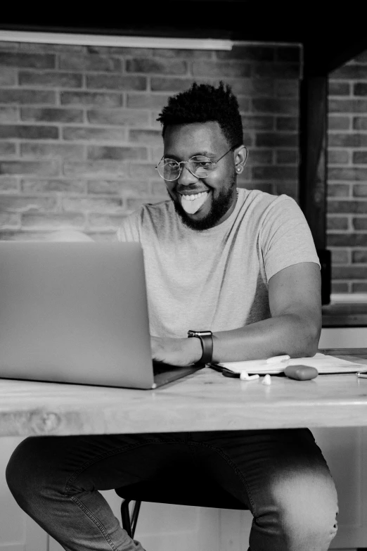 black and white pograph of man with laptop