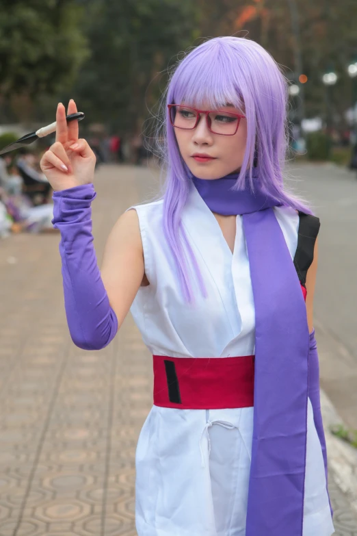 a purple haired girl wearing glasses holding soing