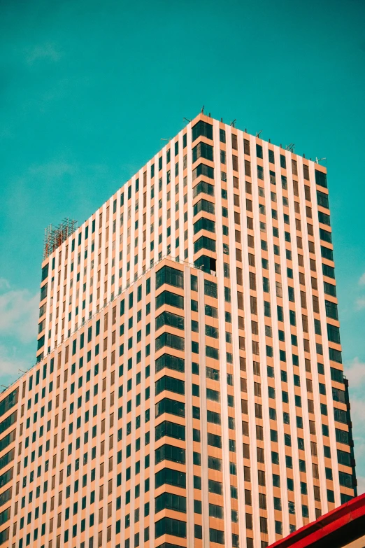 a building with some very tall windows and a sky in the background