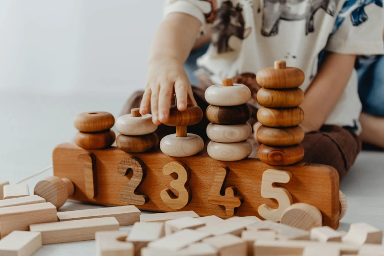 children play with a wooden game set