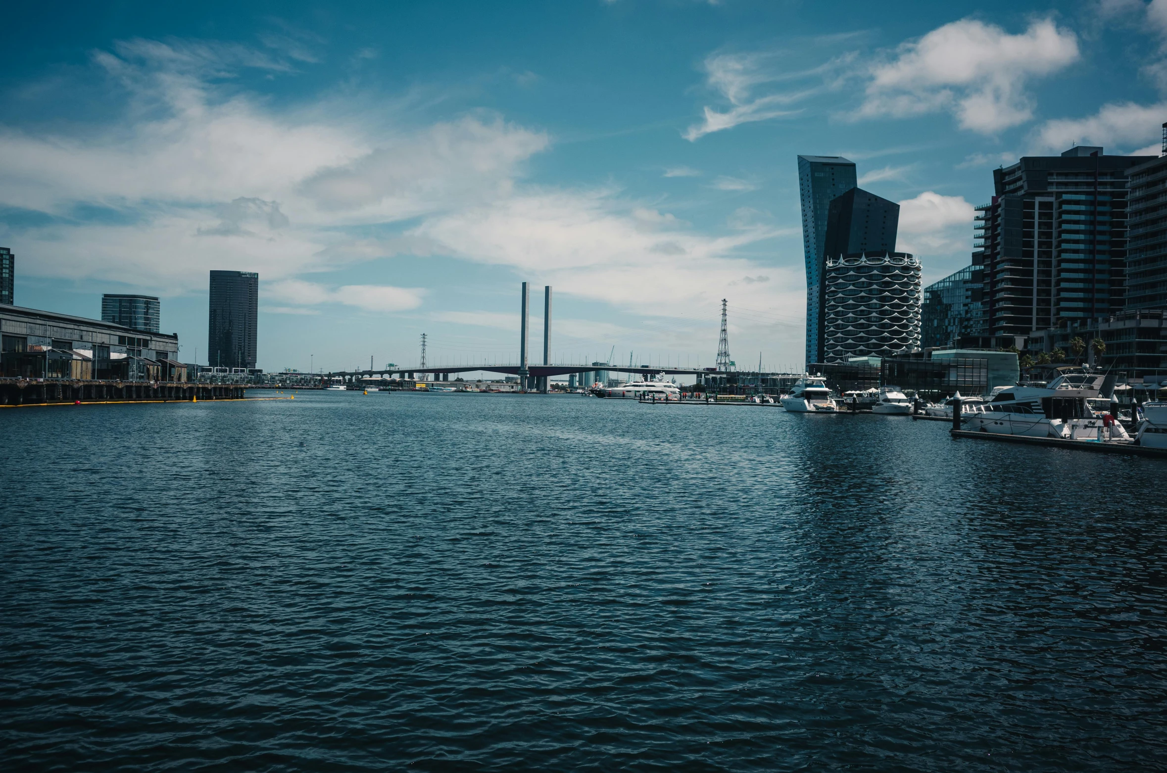 a river with many boats in it and large buildings next to it