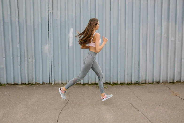 the girl is running down the street wearing running shoes