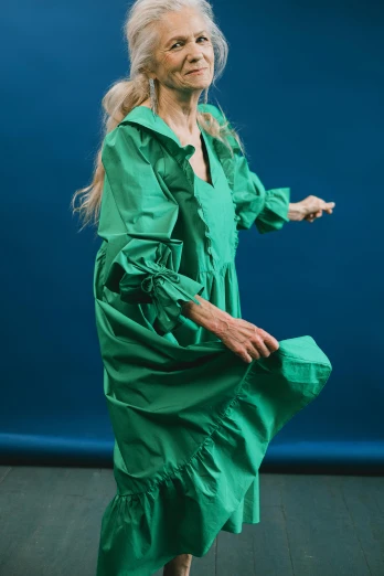 an older woman in a green dress and matching shoes