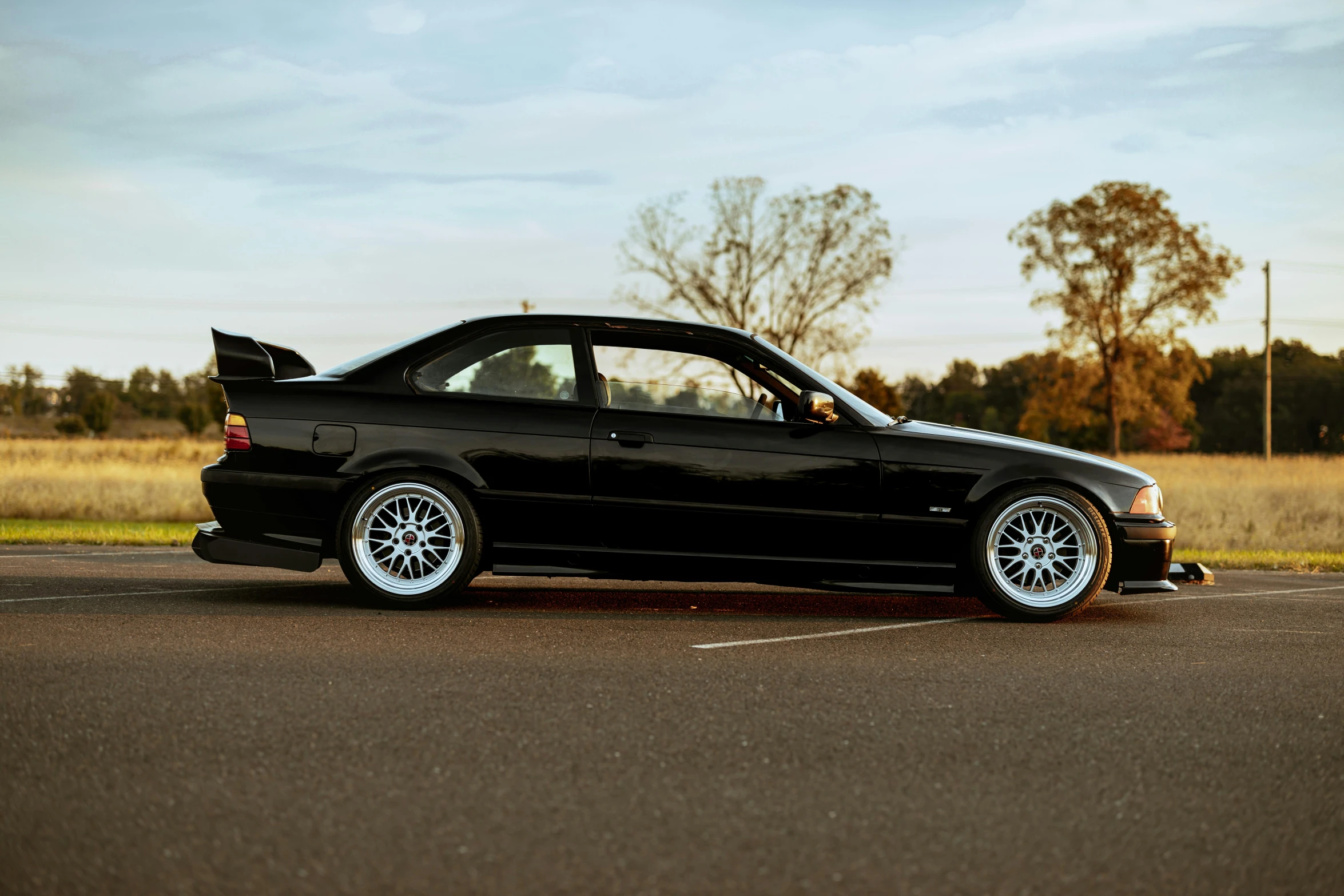 a bmw is parked on the side of the road