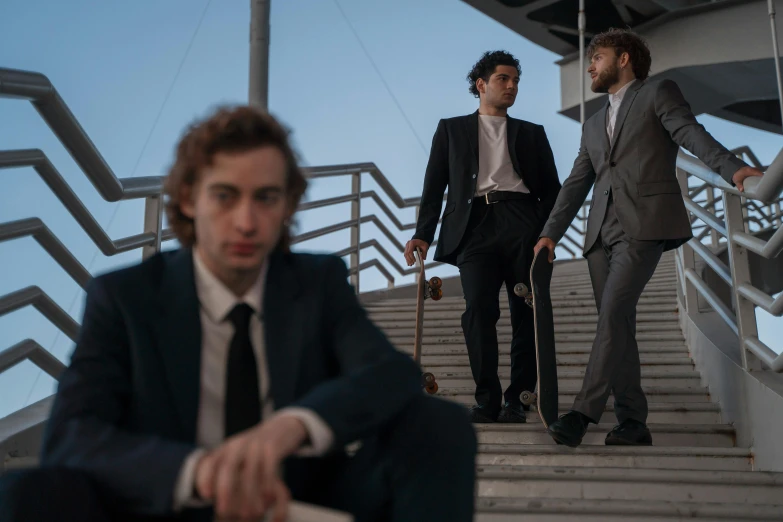 three men are walking up some stairs