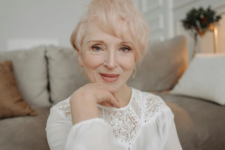 an old woman with blonde hair is smiling