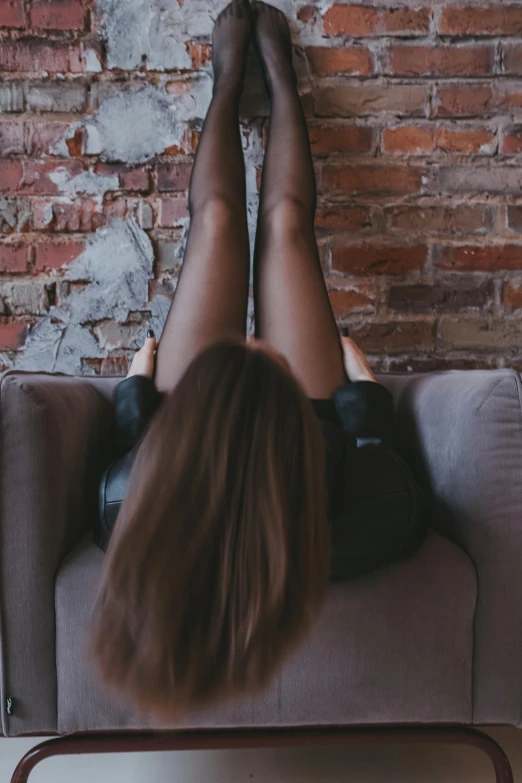 a woman laying on a couch while reading