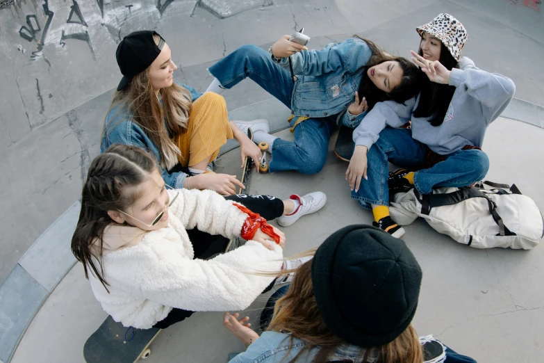 a group of young ladies sitting around each other