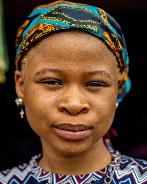 a woman with a turban on her head is looking ahead