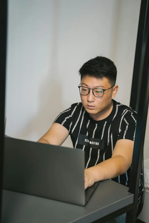 a man is working on a laptop computer