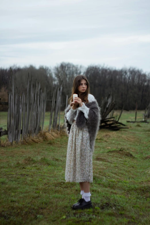 a woman standing on top of a green field