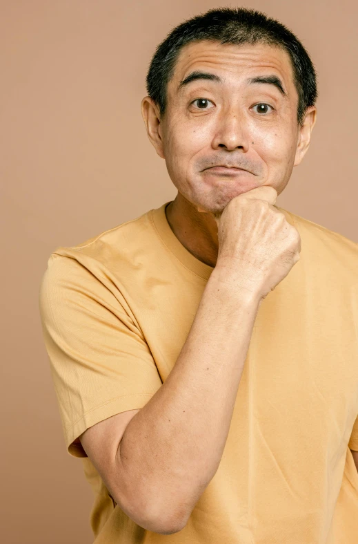 a man poses for a picture while posing for the camera