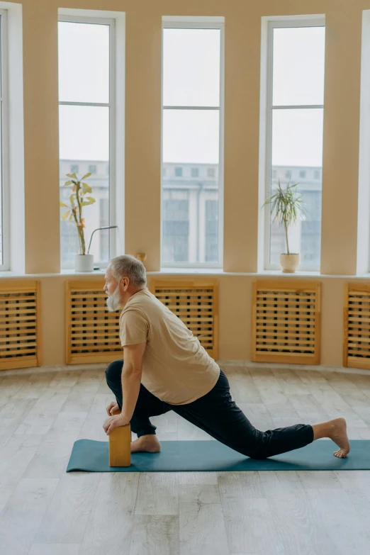 a man doing yoga in a large room