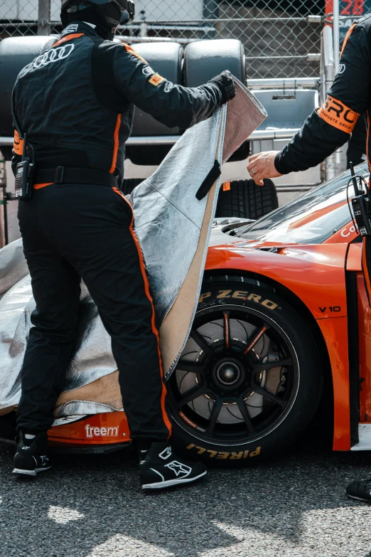 a person that is fixing some kind of car