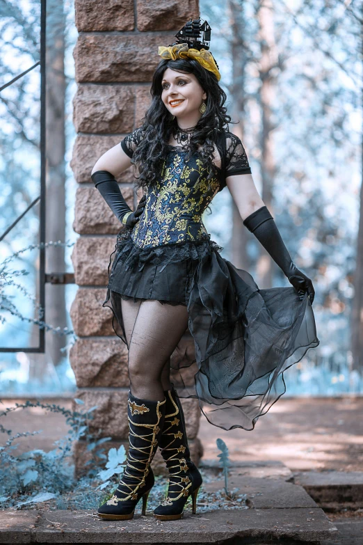 a woman dressed as a witch in a forest