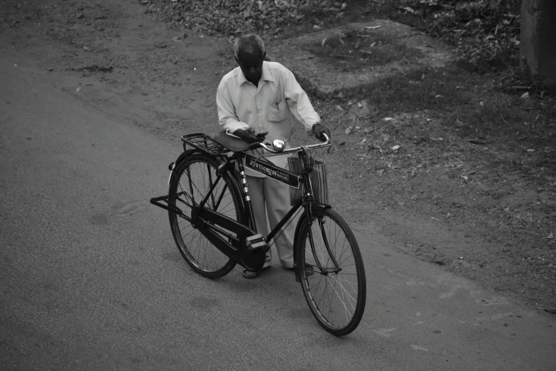 a man on a bike with a bicycle trailer strapped to it