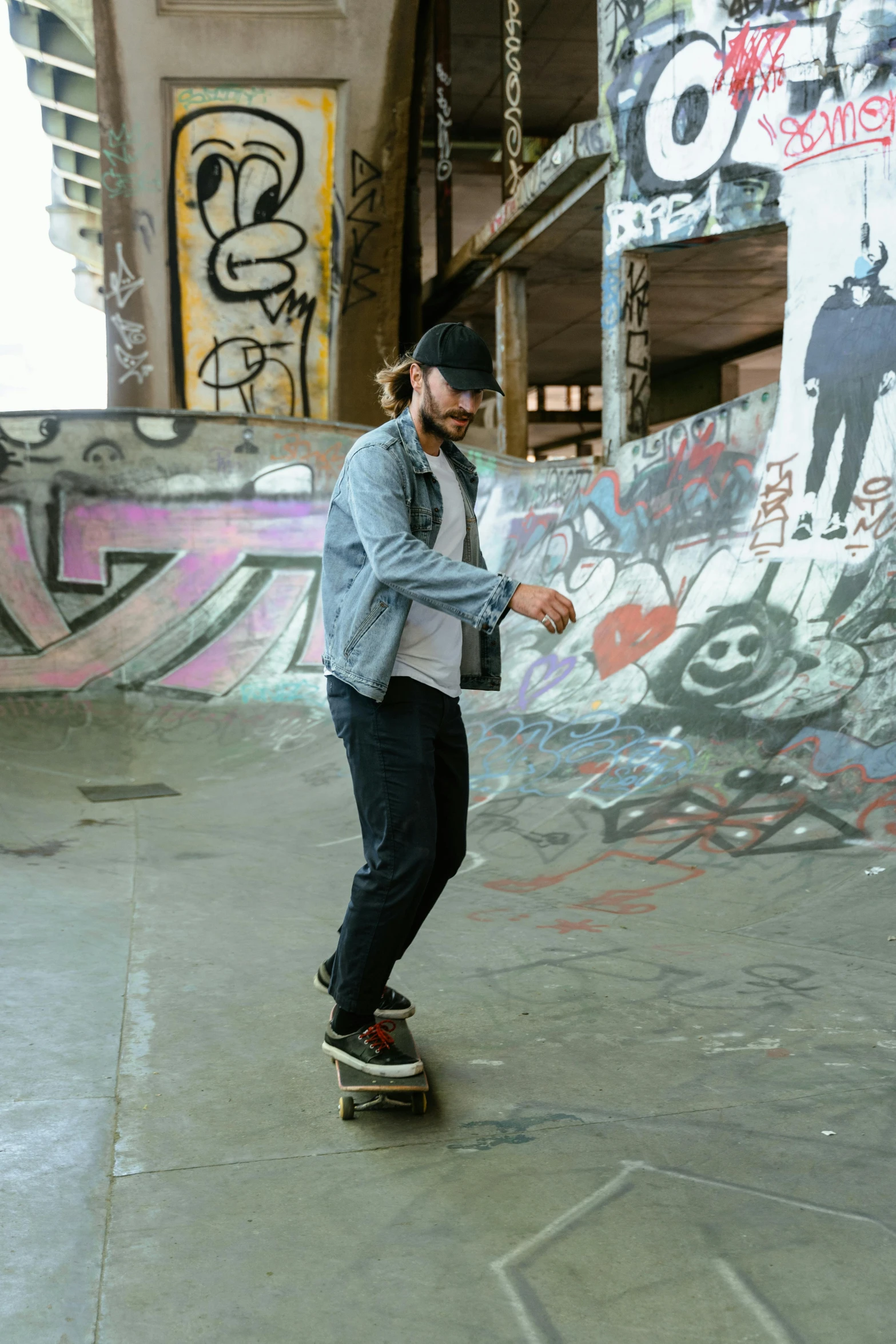 a young man rides his skateboard near graffiti