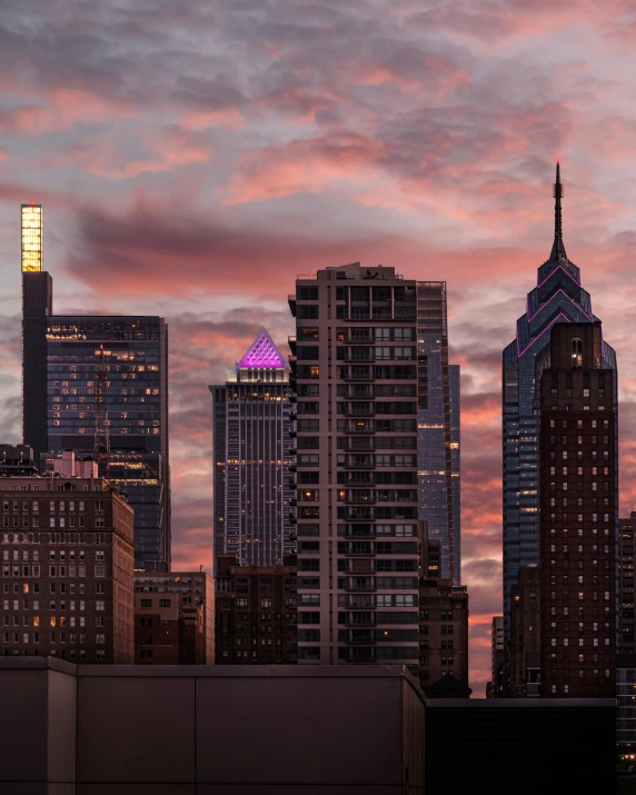 a very colorful lit building sits among the skyline