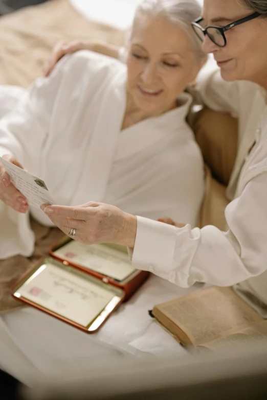 a woman reading an older women's religious book