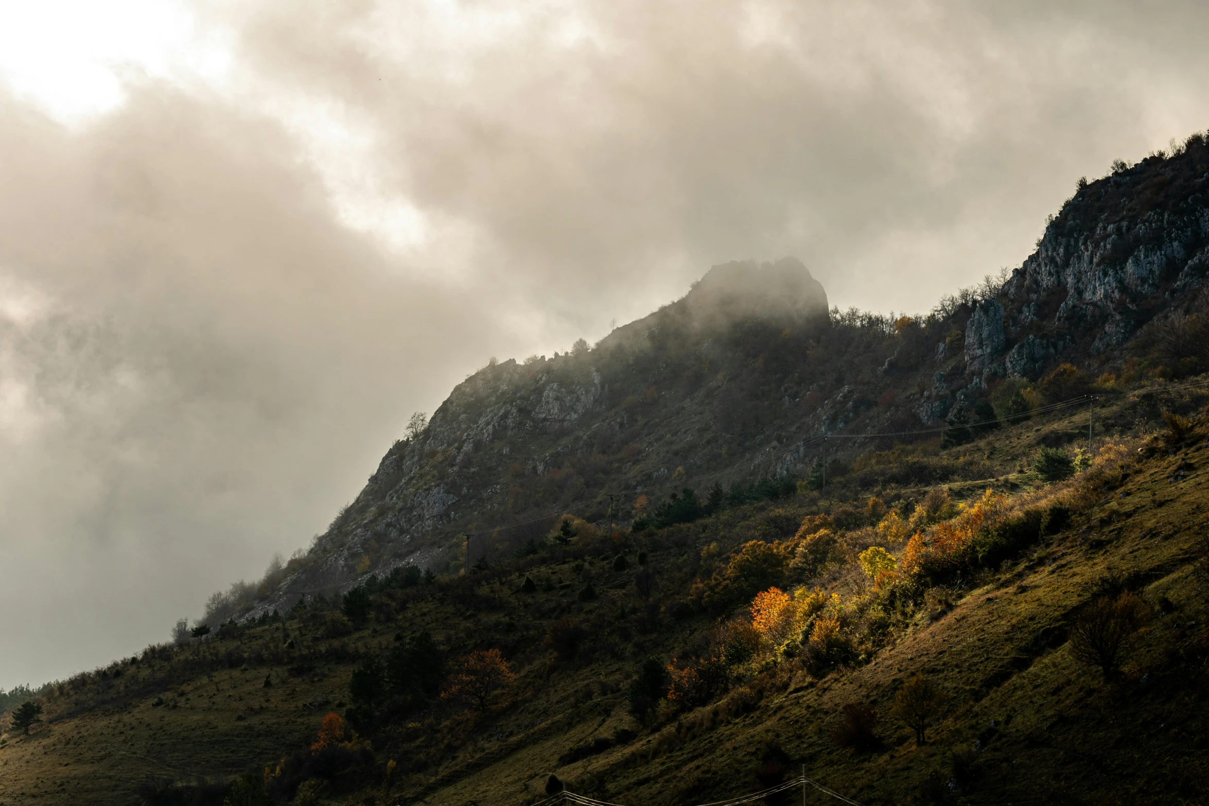 a small tower sits on the top of a hill