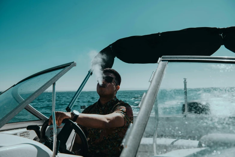 man with a steering wheel in front of a boat