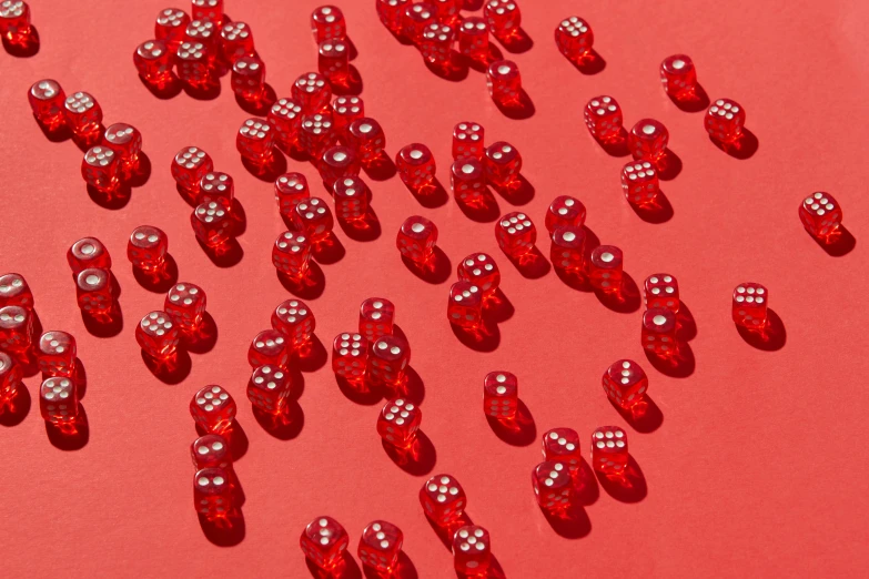 several red shiny objects laying on a surface