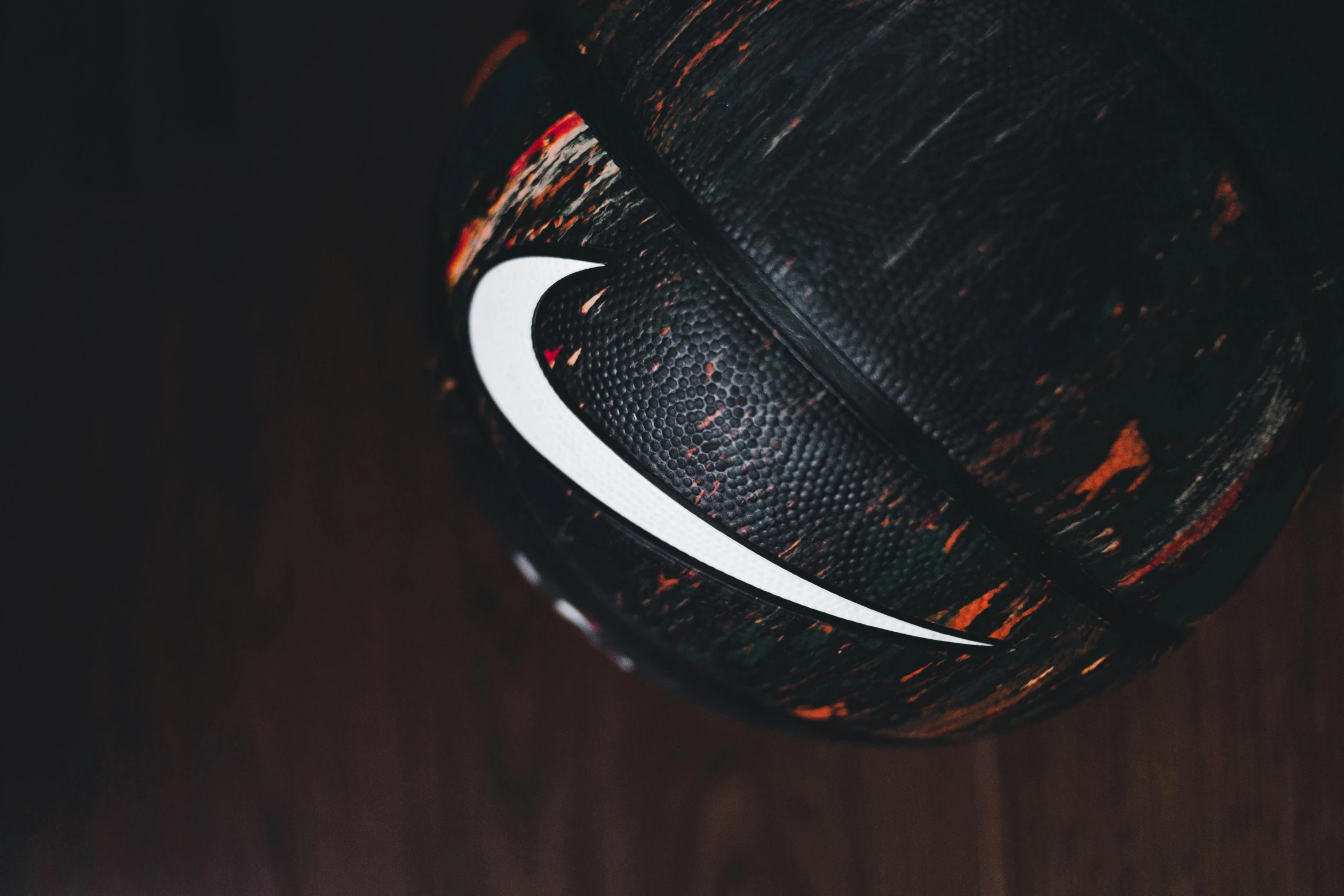 a nike basketball lying on a wooden surface