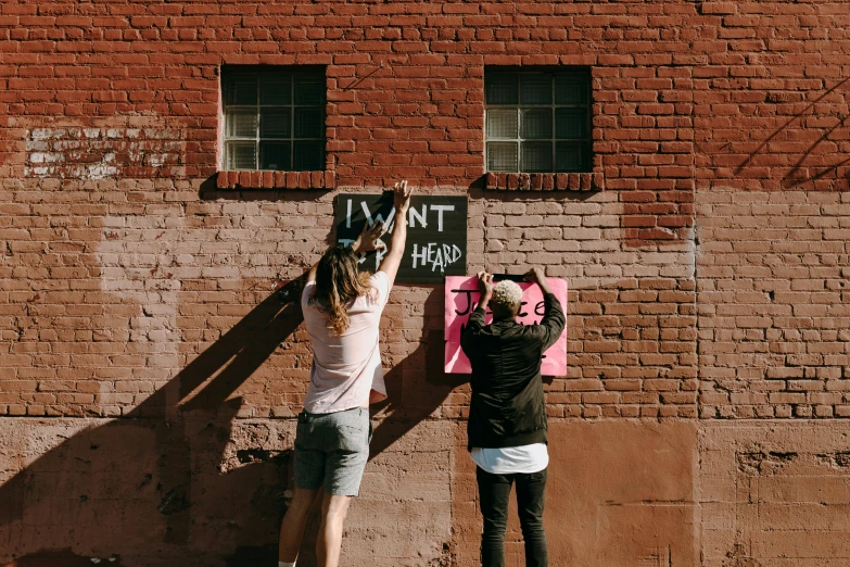 a couple of people that are holding a sign