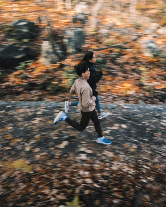 a girl is running while another person looks on