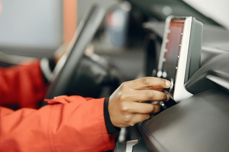 a person wearing an orange jacket with a cell phone