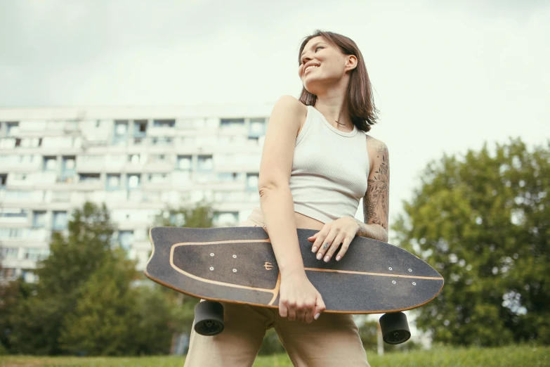 young lady posing with her skateboard in hand