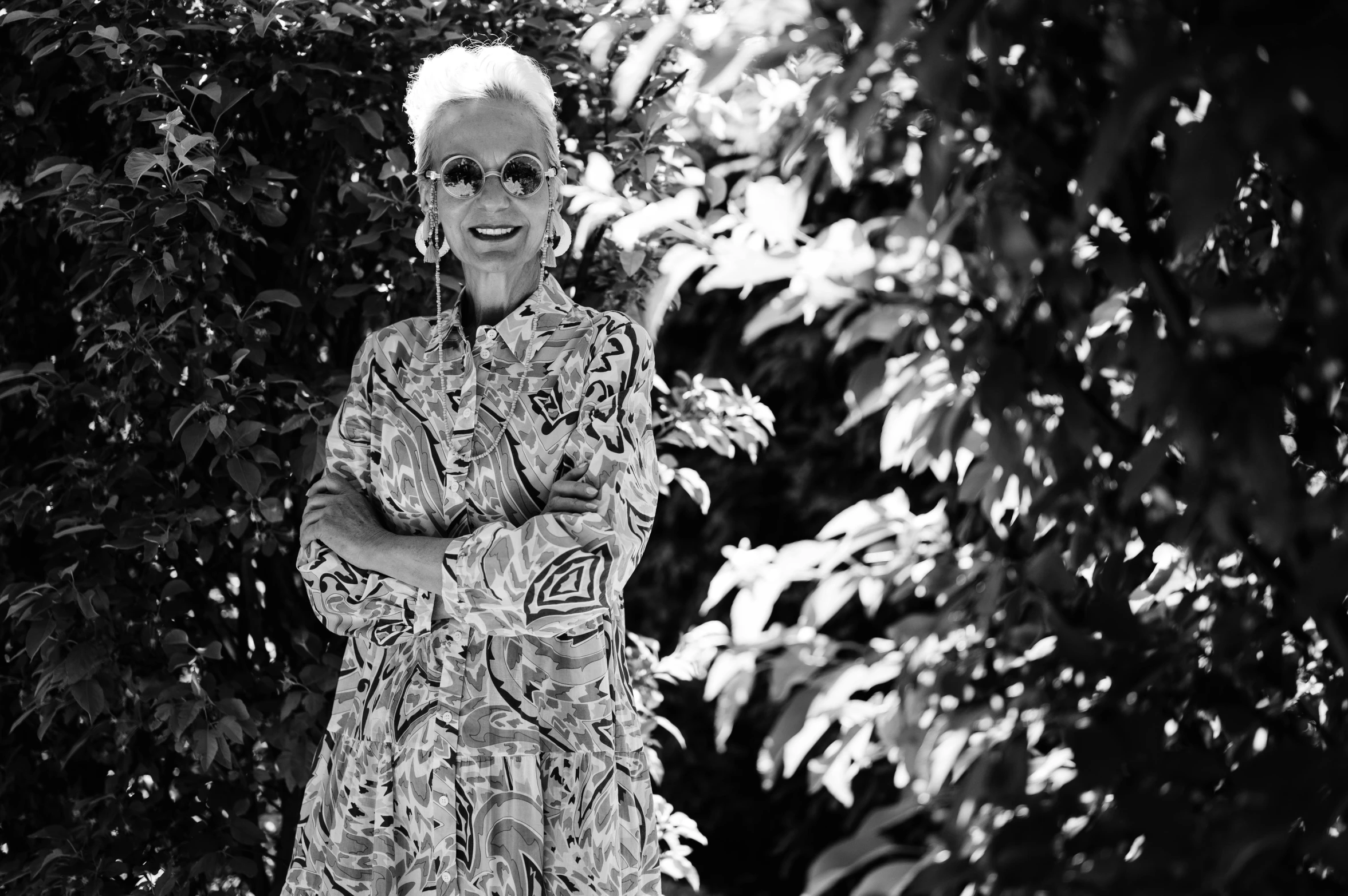 a smiling woman wearing a dress posing for the camera