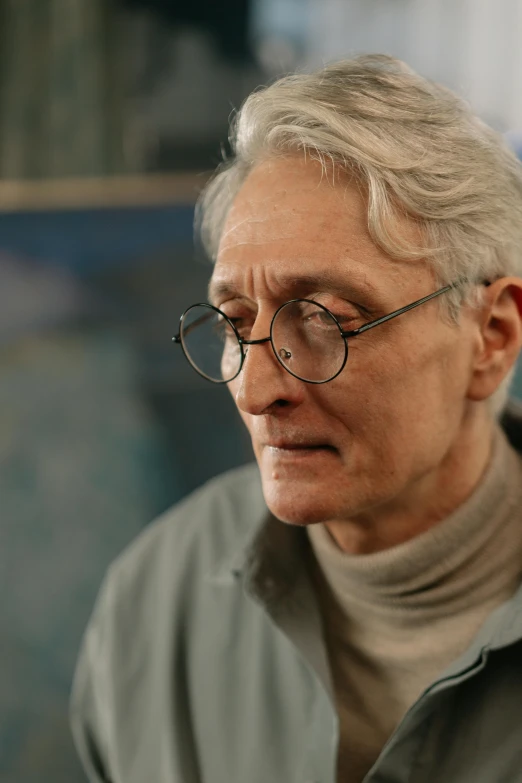 an old man with glasses looks pensive and thoughtful