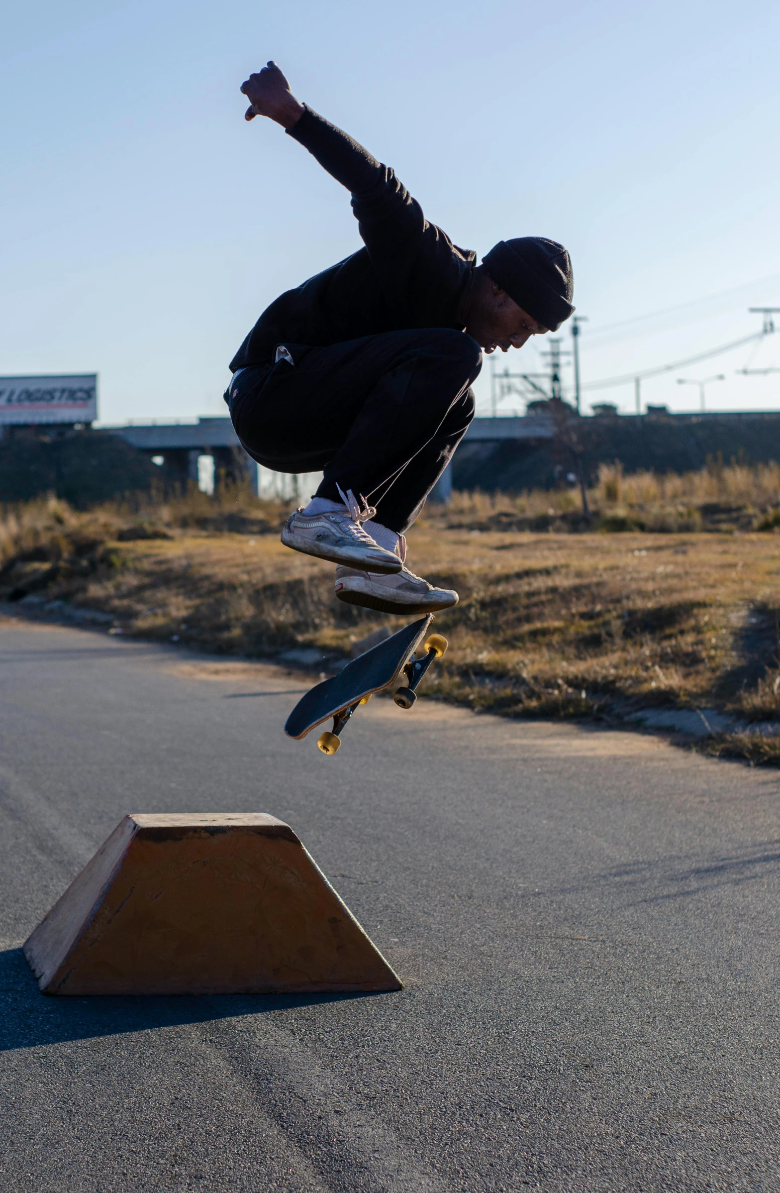 the boy is skateboarding in the park over a ramp