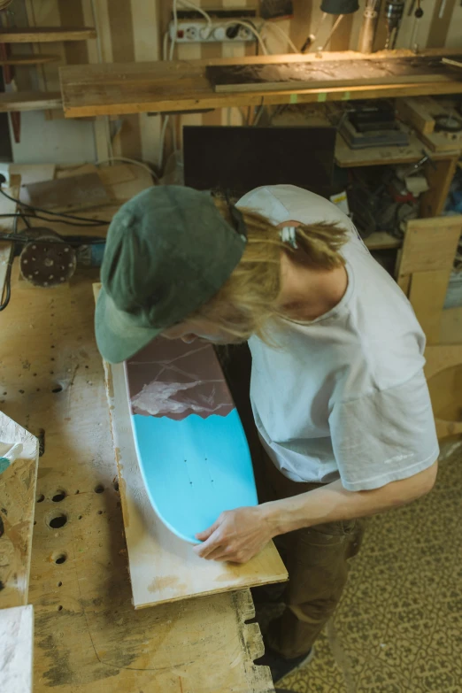 a person working with a skateboard in a garage