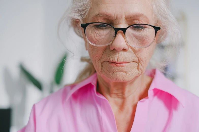 an older woman with glasses is shown posing for the camera